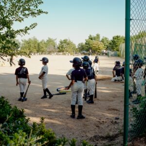 A group of young baseball players standing next to each other