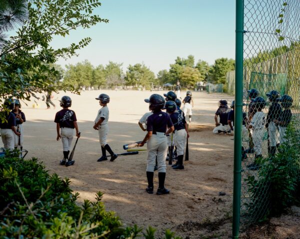 A group of young baseball players standing next to each other